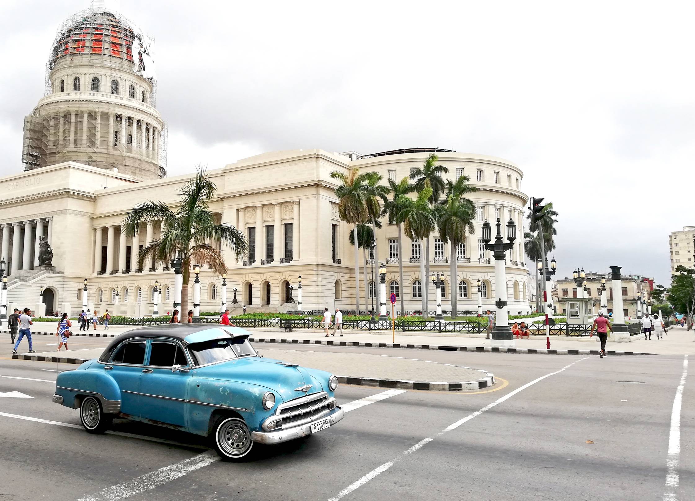 Antique blue car outside of the Havana Capitol building