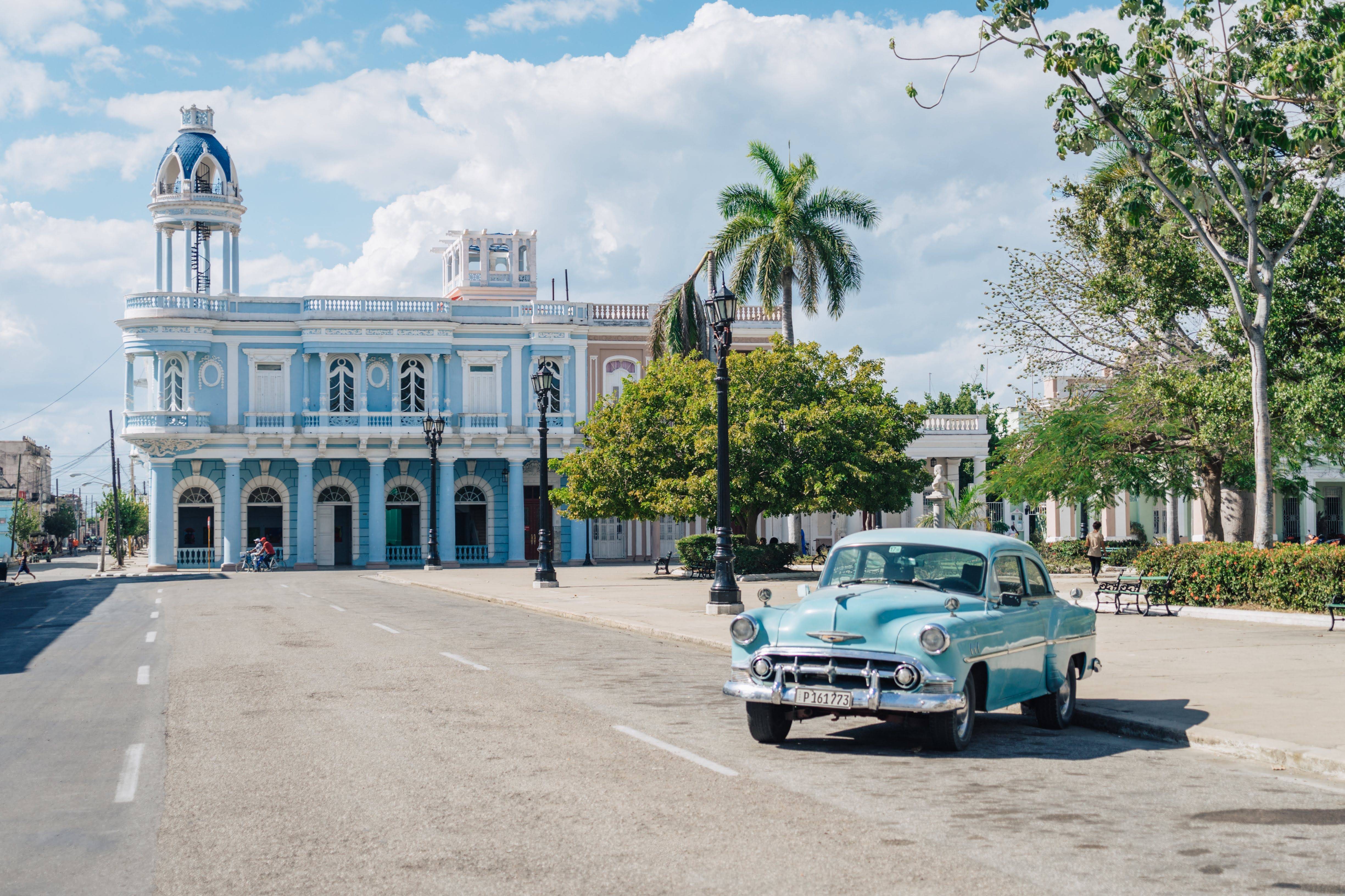Classic car in front of Palacio Ferrer in Cienfuegos