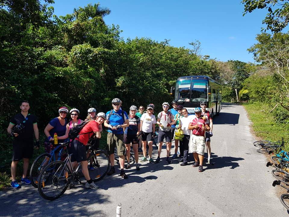 cycling group gathered in front of tour bus